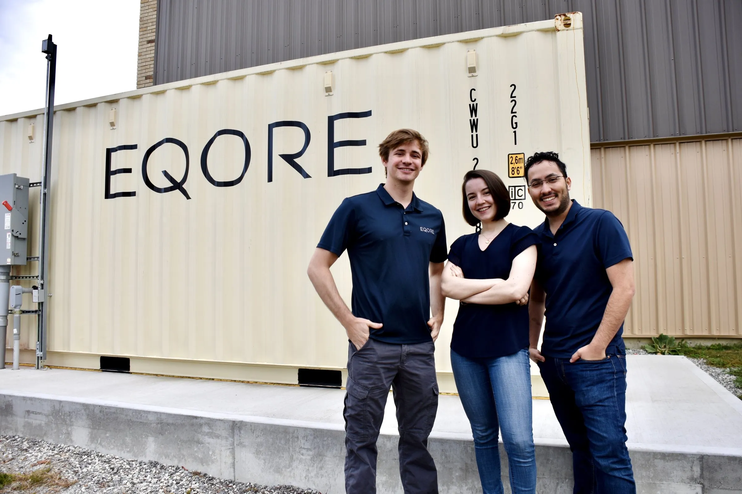 EQORE founders Donald Groh, Valeriia Tyshchenko and Jorge Nin standing in front of an EQORE battery container