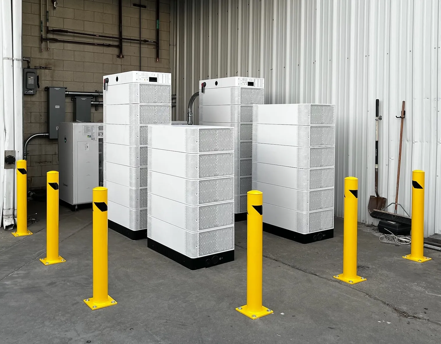Stacked battery modules ringed by yellow bollards in a loading bay at ThermoFusion in Hayward